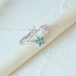 Macro shot of S925 silver ring featuring three colorful zircon flowers in a cluster design