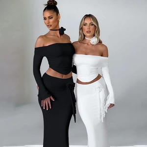 Detailed view of the 3D floral accent on a two-piece crop top and long skirt set