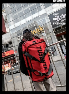Rear view of a large red multifunctional travel backpack with black nylon straps
