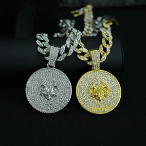 Close-up of gold and silver pavé-set Capricorn zodiac pendants on chunky Cuban chains