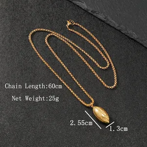 Golden football pendant necklace in stainless steel on black textured background