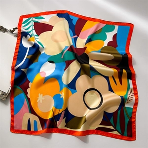 Luxury floral pattern silk scarf with elegant orange and blue tones on white background