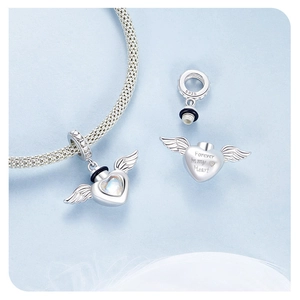 Detailed macro view of S925 sterling silver heart wing charm with Forever in my Heart carving