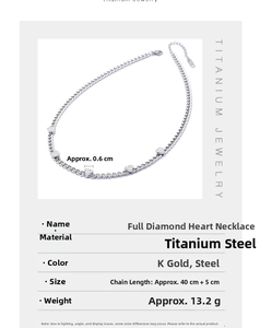 Macro view of titanium steel necklace showing five iced-out heart pendants and silver chain