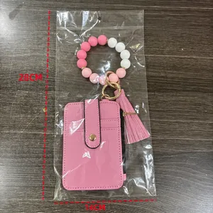 Pink silicone bead bracelet keychain with leather card holder and tassel pendant