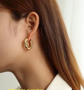 Detailed view of heavy-duty gold twisted hoop earrings with 18K gold plating finish