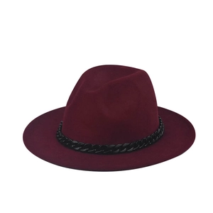 Detail of burgundy wool fedora hat featuring a chunky black chain band accessory