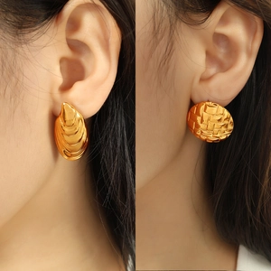 Textured gold shell earrings with embossed patterns and layered geometric textures