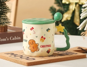 Close-up of Christmas ceramic mug with gingerbread man motif and green lid and spoon
