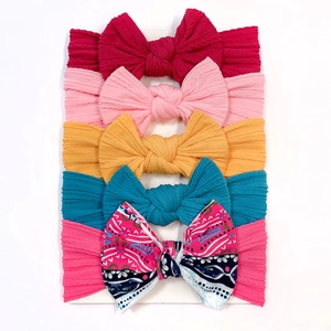 Detail of 5-piece baby headbands set featuring textured bows and floral nylon bands