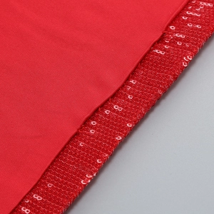 Macro detail of red sequins and ribbed knit fabric on a slim-fit sleeveless party dress