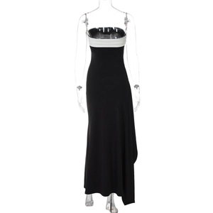 Detailed side view of black and white color-block maxi dress with high side slit detail