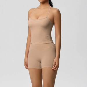 Detailed view of nude yoga set featuring slim camisole and high-waist shorts in matte finish