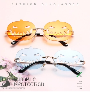 Detail of pumpkin-shaped Halloween sunglasses in orange and light blue lens colors