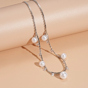 Detailed macro view of vintage pearl and starfish pendant necklace on display