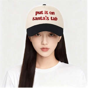 Detailed red embroidery of Put It on Santa's Tab text on a two-tone baseball cap