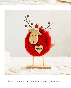 Detail of wool felt reindeer ornament with XMAS heart tag and red berry antlers