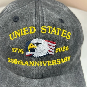 Close-up of eagle embroidery on a washed dark gray 250th anniversary baseball cap