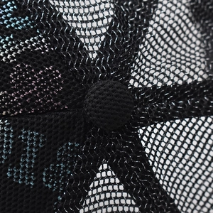 Detail of breathable mesh texture and gradient color embroidery on the black trucker hat