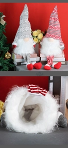 Detail of plush gnome tree topper showing the soft white inner fabric of the pointed hat