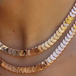 Detail shot of rose gold crescent moon scale layered necklace on woman neck