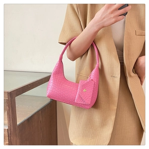 Detailed shot of pink woven shoulder bag with matching mini coin purse and gold hardware