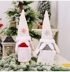 Detail of Christmas gnome wine bottle covers with snowflake embroidery and faux fur beards