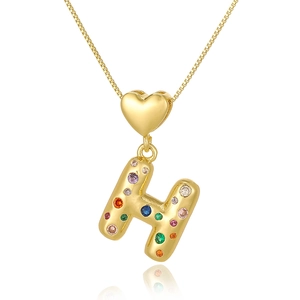 Detailed shot of a gold heart pendant with a multi-colored zircon-inlaid letter H