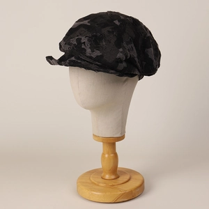 Distressed dark grey asymmetric newsboy cap on mannequin head for a stylish vintage look