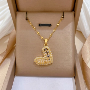 Luxurious titanium steel heart pendant necklace with white zircons in a beige jewelry box