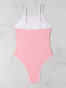 Detail of pink ribbed swimsuit with white contrast binding and adjustable shoulder straps