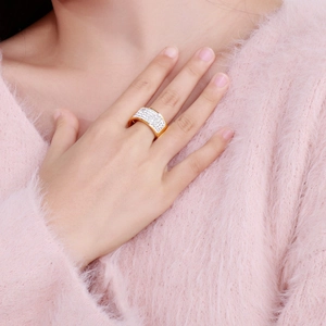 Close-up of model wearing wide 18k gold plated ring with micro-pave zirconia setting