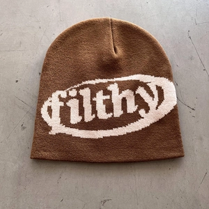 Macro detail of brown beanie featuring high-density jacquard knit filthy logo
