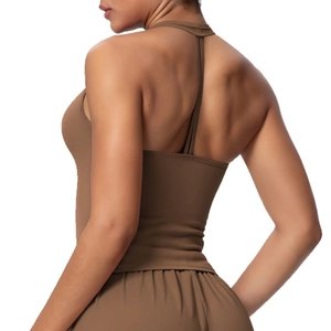 Women's brown racerback sports bra and pleated skirt set for fitness and yoga