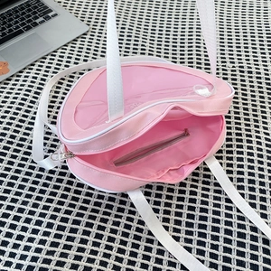 Internal view of pink heart ita bag showing the main compartment and zipper pocket