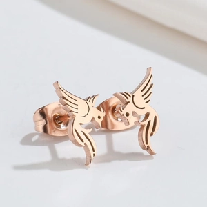 Elegant 18K rose gold bird phoenix stud earrings set against a minimalist gray background