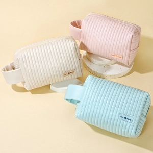Three PU leather cosmetic bags in pink beige and light blue with stripe quilting