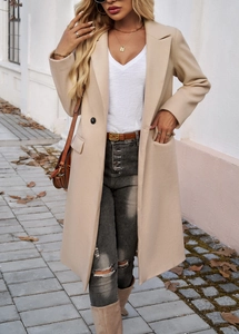 Detail of beige double-breasted coat with classic lapels and high-quality wool finish