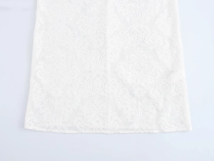 Close-up of elegant white lace fabric showing intricate floral patterns and mesh texture
