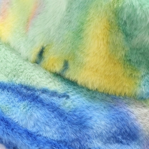 Close-up of colorful tie-dye faux fur fabric showing thick texture on a bucket hat