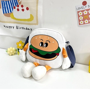 Detail of creative canvas burger bag featuring 3D plush arms and blue shoulder strap