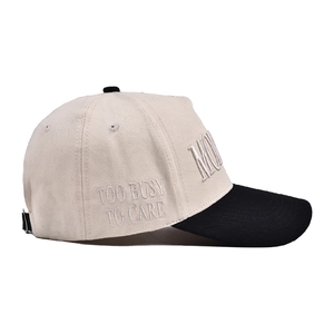Detail of contrast baseball cap with TOO BUSY TO CARE embroidery and cotton twill texture