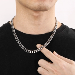 Polished silver stainless steel Cuban link chain necklace on male model wearing black T-shirt