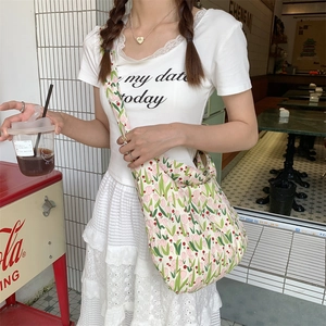 Detail of canvas shoulder bag featuring tulip prints and a wide comfortable strap