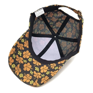 Internal view of floral baseball cap showing 100% polyester fabric and mesh lining