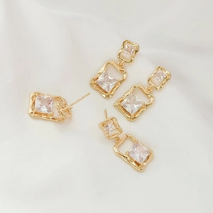 14K gold plated geometric earrings with clear zircon stones on soft silk background