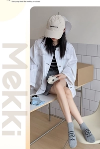 Detailed view of light gray knit crew socks with smiley face and relax letter prints