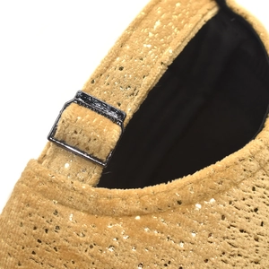 Close-up of golden sequin velvet baseball cap with adjustable metal buckle strap