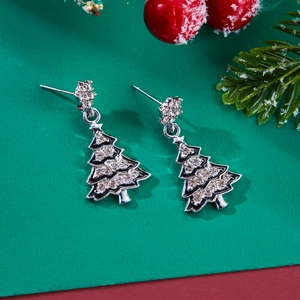 Close-up of silver Christmas tree stud earrings with black enamel and sparkling crystals