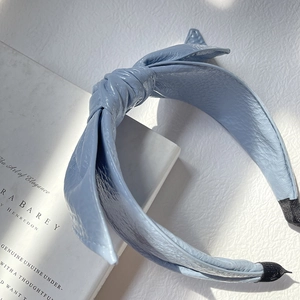 Light blue faux leather knotted headband with lychee texture and wide fashion design